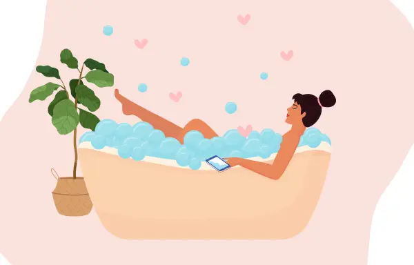 やさしい泡風呂に浸かりながらスマホで動画を楽しむ女性。リラックスしながら自分と向き合う、セルフラブの時間をイメージ